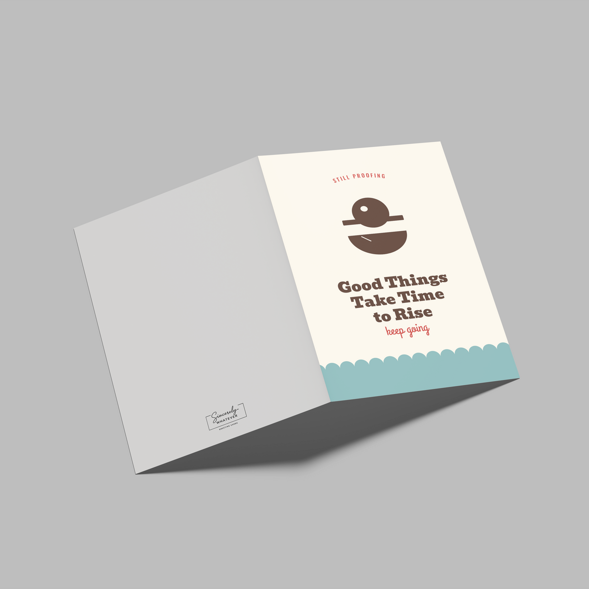 A folded greeting card shown open on a plain gray background. The front panel is off-white with a brown illustration of a coffee cup and the text 'Good Things Take Time to Rise' with smaller red text above and below.