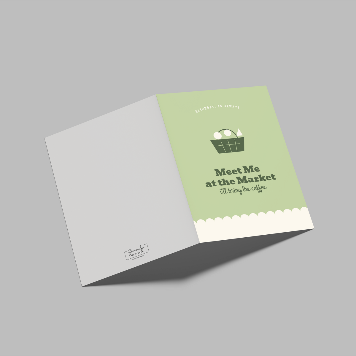 An open greeting card or booklet shown on a plain gray background. The right panel is light green with a small basket illustration and the text 'Meet Me at the Market' and 'I'll be right away!'; the left panel is white with a small logo near the bottom.