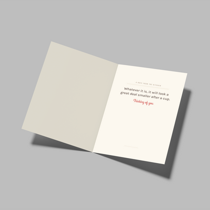 An open folded card or booklet on a plain gray background, showing a cream interior page with a quote attributed to Happy Slobby.