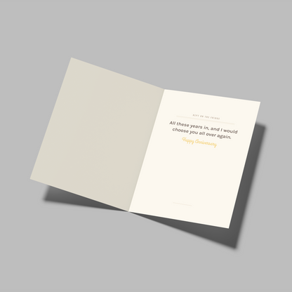 An open folded card or booklet on a plain gray background, showing a cream interior page with a quote attributed to Happy Slobby.