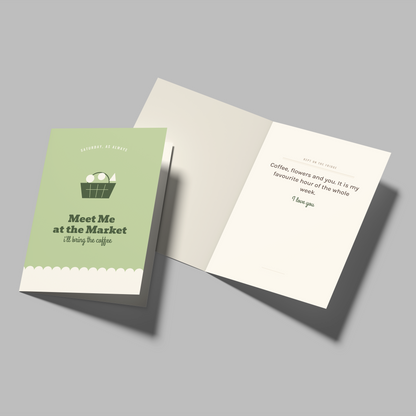A greeting card set shown on a plain gray background, with one closed card featuring a light green cover and the text 'Meet Me at the Market I'll be at the pigsty' and an illustration of eggs, and one open card showing a white interior with a short poem.