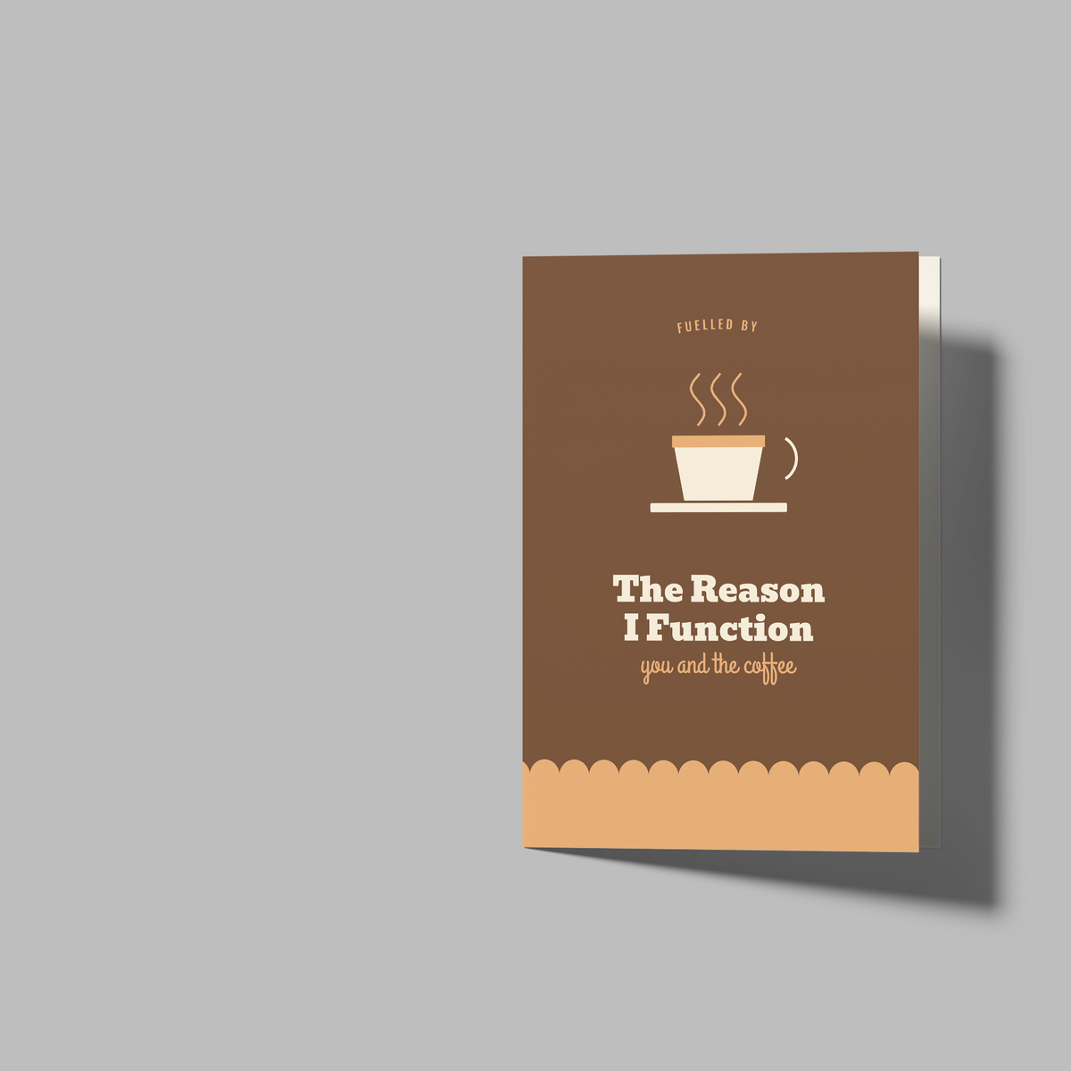 A mockup showing a folded blank white booklet or brochure alongside a printed sample cover card with a brown coffee cup design and the text 'The Reason I Function' on a light gray background.