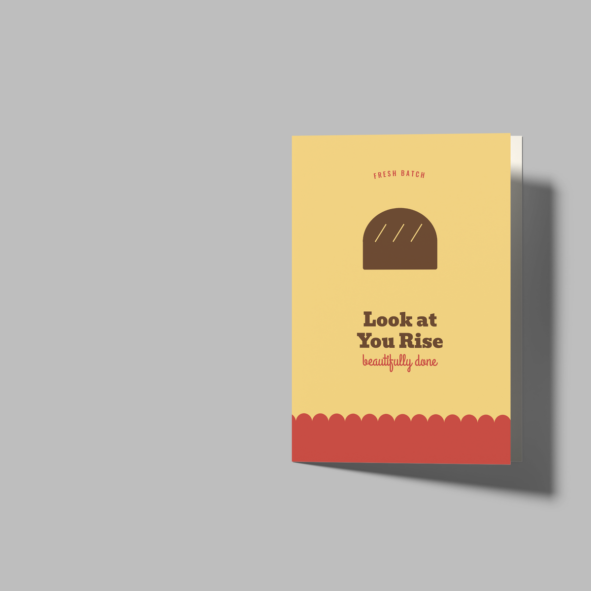 A set of blank greeting cards shown on a plain gray background: one closed card standing upright with a yellow bakery-themed front and one open blank card, plus another open card viewed from the back. No person, animal, or real environment is present.