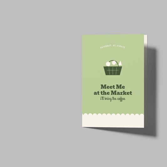 A mockup showing a folded greeting card and two blank folded card templates on a solid gray background. The card on the left features a sage green front cover with a basket of eggs illustration and the text 'Meet Me at the Market (I'm your sign)'.